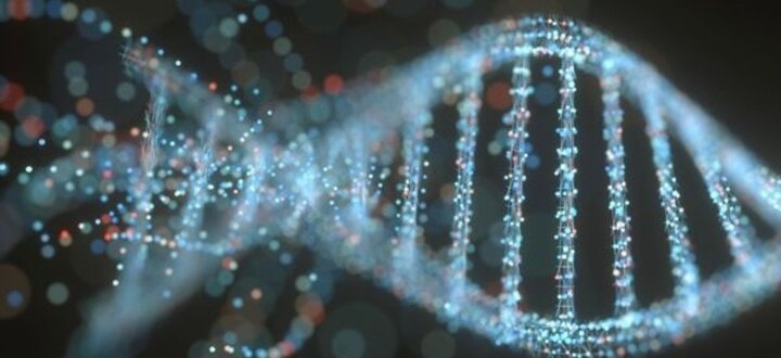 DNA double helix made of glowing dots, set against a dark blurred background.